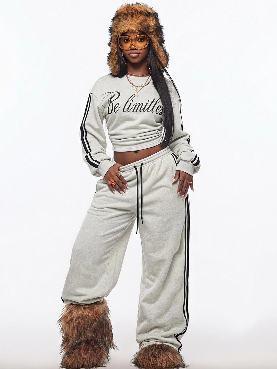 Women's casual black long sleeve knitted pullover sweatshirt featuring a round neck and cinched waist design.