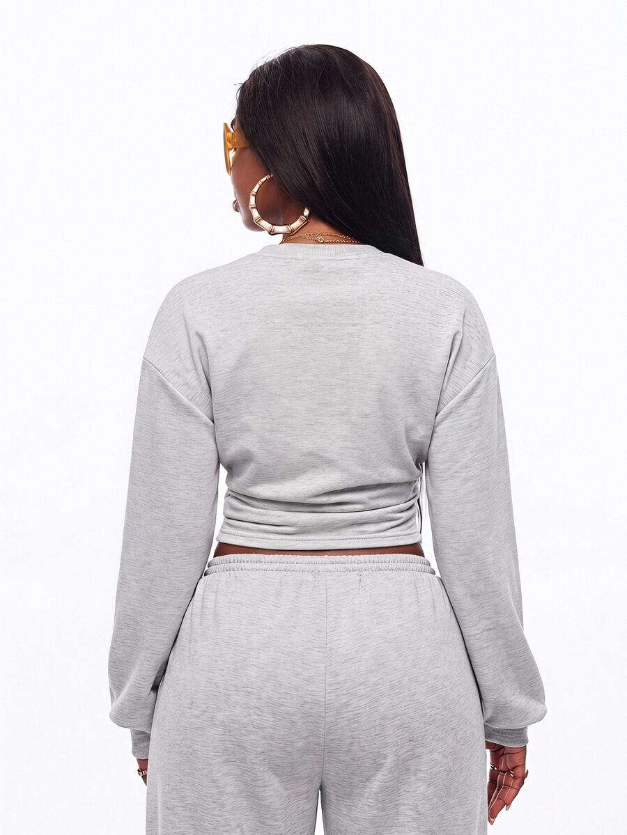 Women's casual black long sleeve knitted pullover sweatshirt featuring a round neck and cinched waist design.