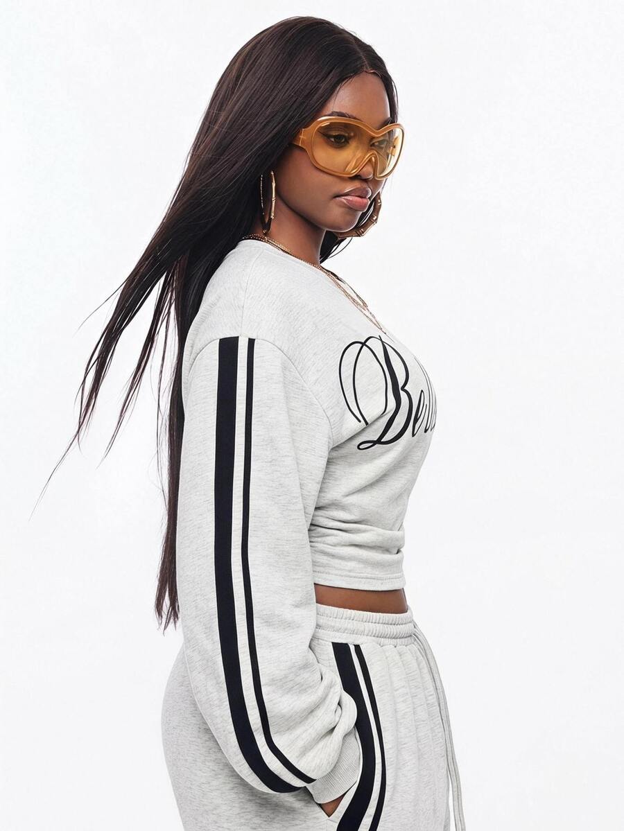 Women's casual black long sleeve knitted pullover sweatshirt featuring a round neck and cinched waist design.