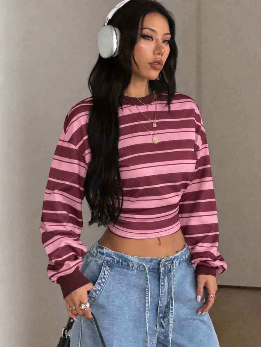 Women's striped pullover sweatshirt featuring drop shoulder long sleeves and a classic round neckline.