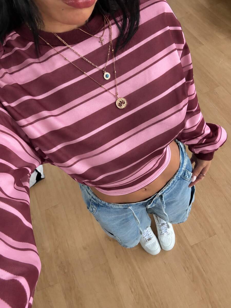Women's striped pullover sweatshirt featuring drop shoulder long sleeves and a classic round neckline.