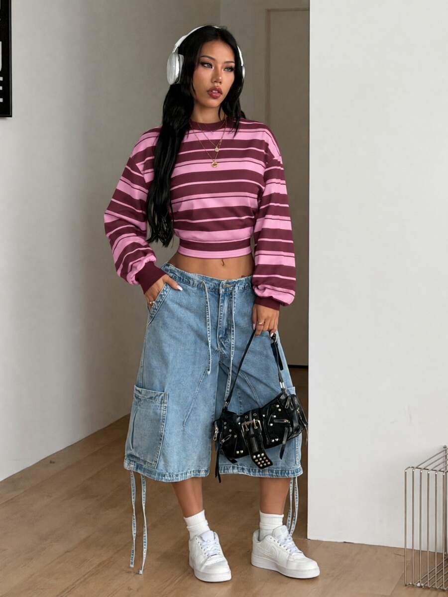Women's striped pullover sweatshirt featuring drop shoulder long sleeves and a classic round neckline.