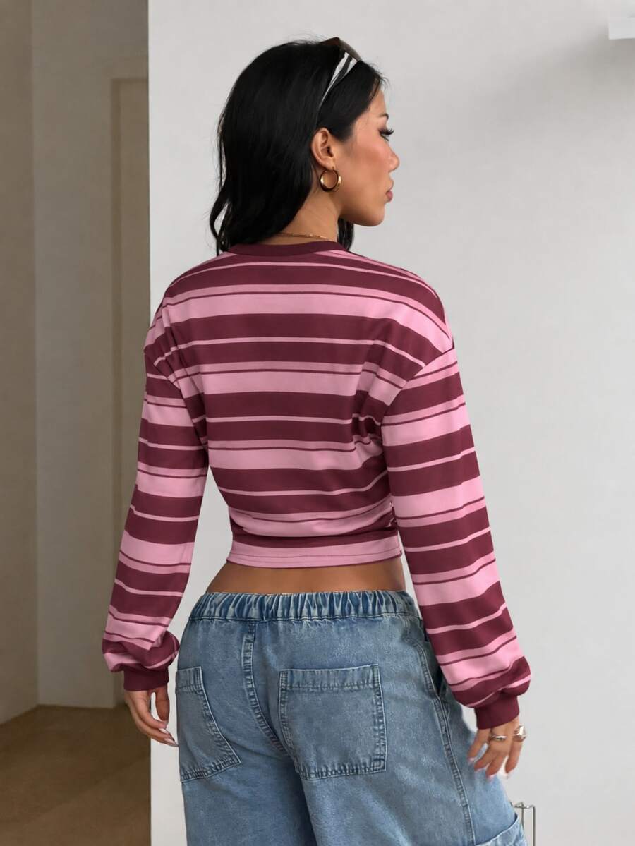 Women's striped pullover sweatshirt featuring drop shoulder long sleeves and a classic round neckline.