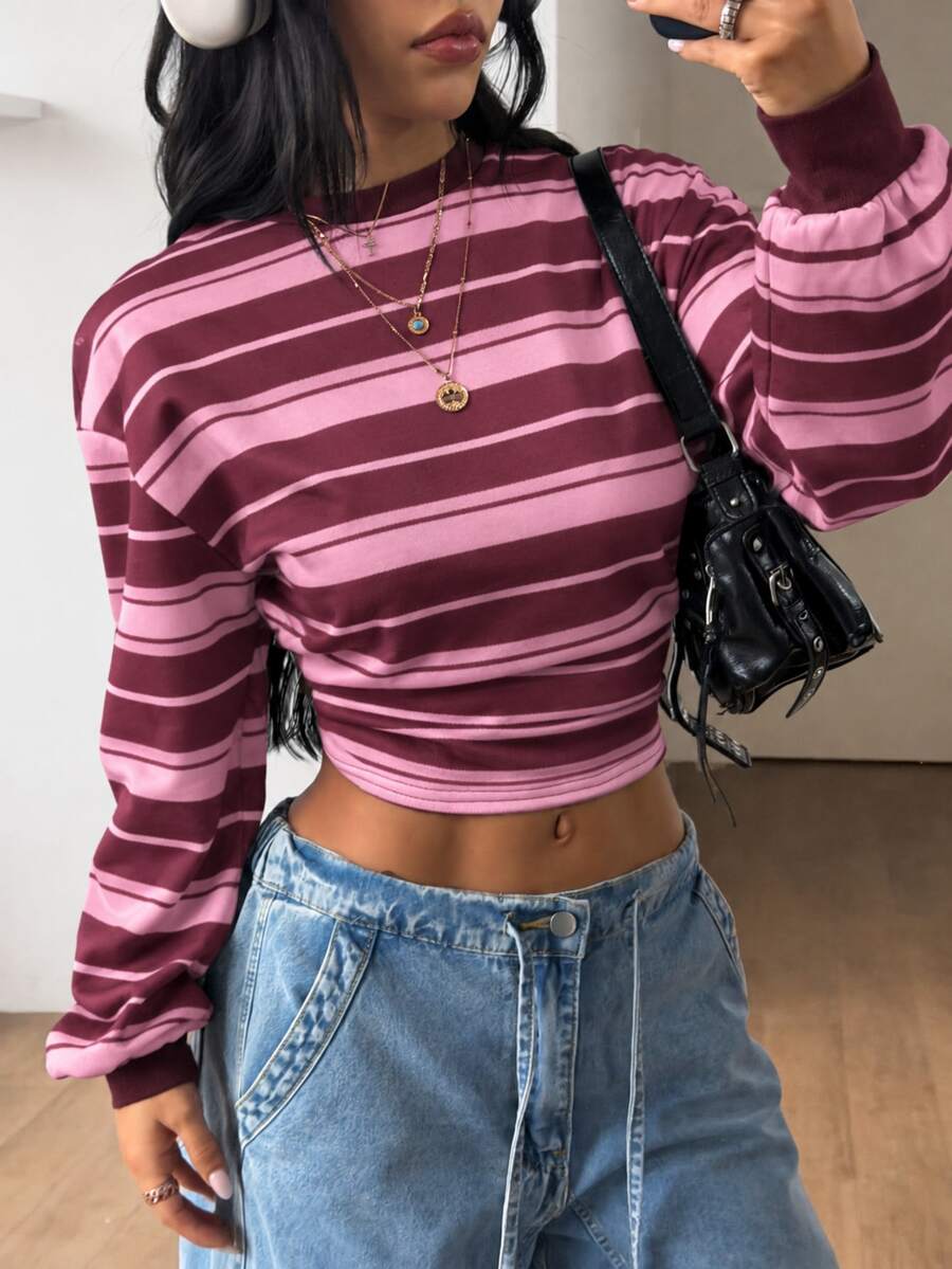 Women's striped pullover sweatshirt featuring drop shoulder long sleeves and a classic round neckline.
