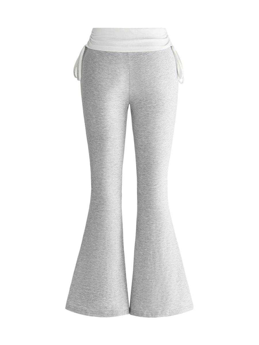 Women's low waist flare leg pants featuring an elastic drawstring waistband and ruched detail in knitted fabric.