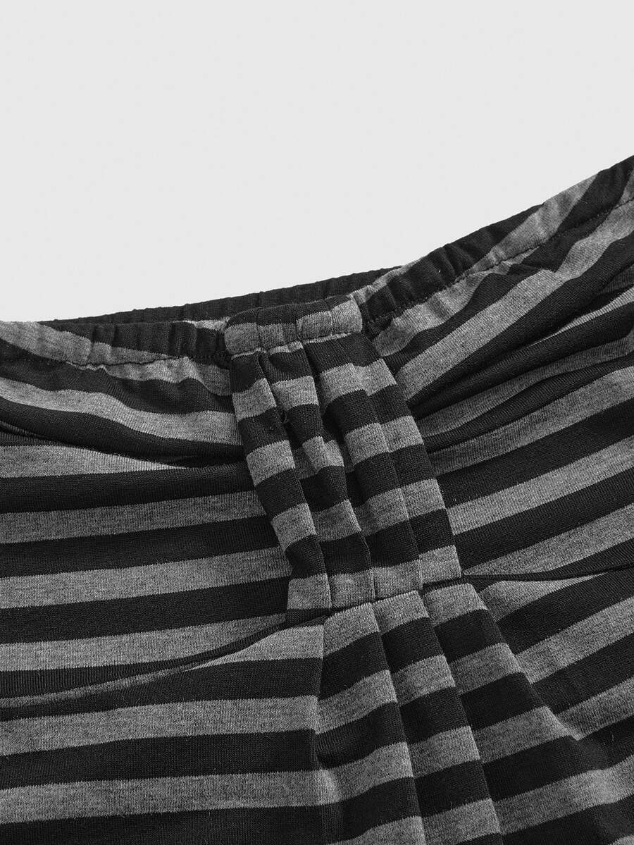 Women's striped strapless tube top featuring ruched detailing, flared hem, and stretchy knit fabric.