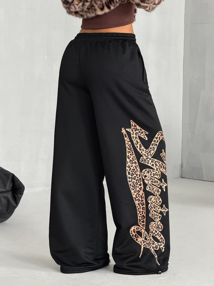 Women's loose fit wide leg graphic sweatpants in light grey with an elastic drawstring waistband