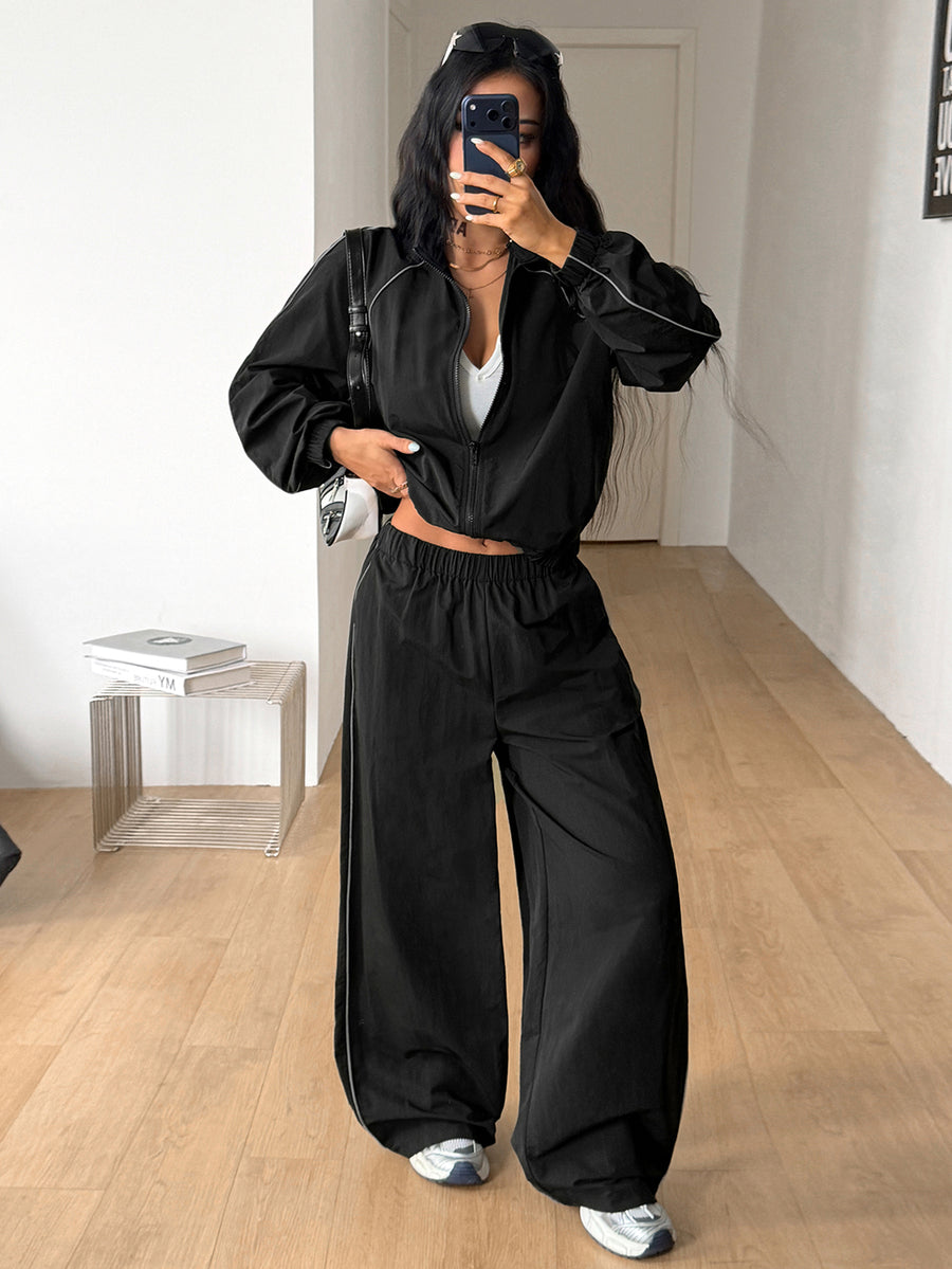 Women's black casual reflective windbreaker sports set featuring a loose stand collar zip jacket and matching unlined pants.