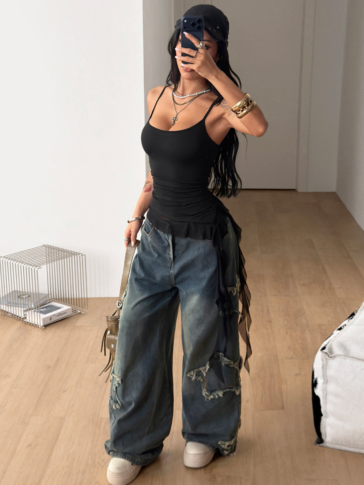 Women's slim fit casual cami top featuring spaghetti straps, ruched detailing, and a ruffle hem.