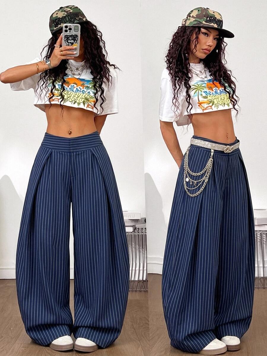 Women's brown striped wide leg pants with a low waist, curved hem, and loose casual fit in woven fabric.