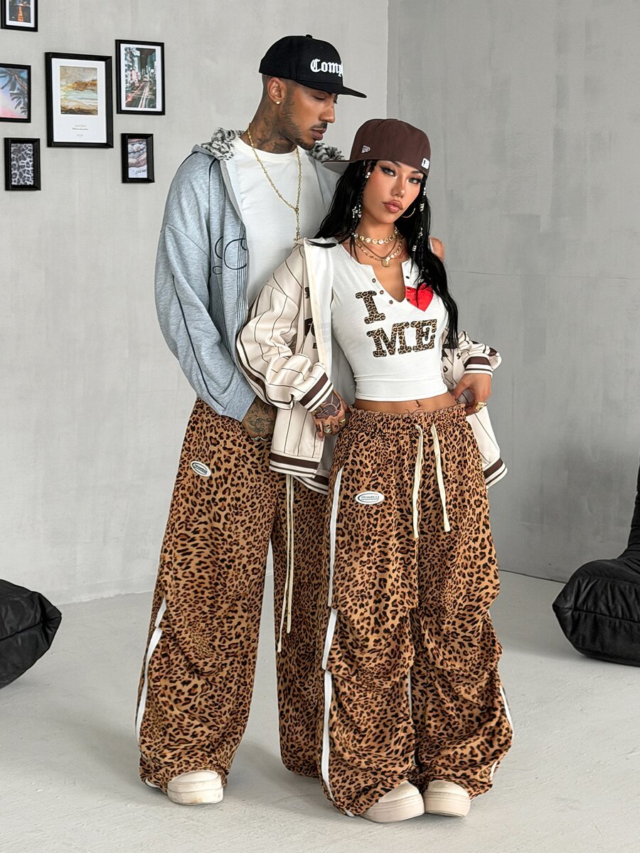 Women's black and white striped wide leg pants featuring an elastic drawstring waistband, side pockets, and a loose straight leg fit.