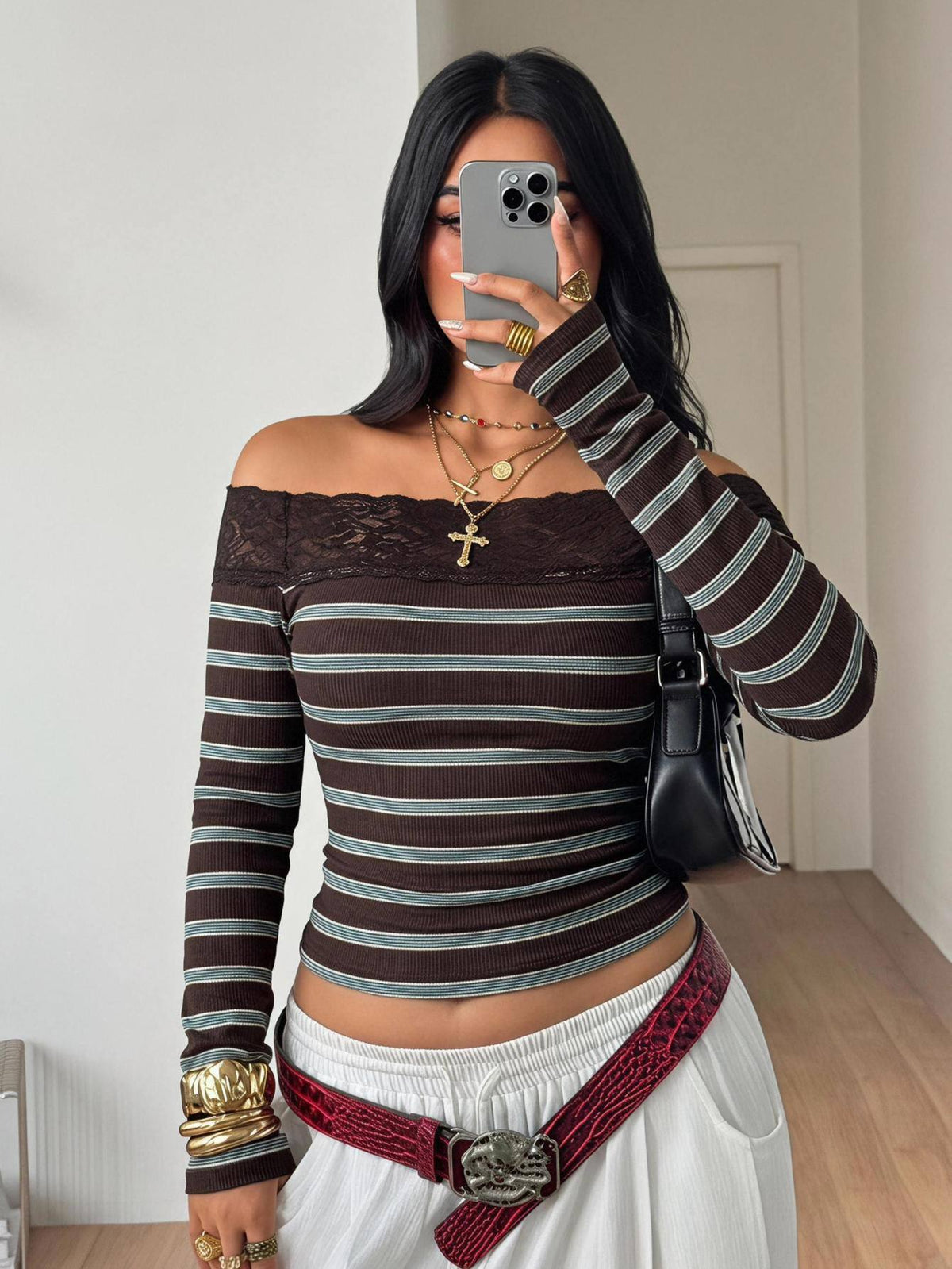 Women's striped off the shoulder long-sleeve top with contrast lace trim and ribbed knit texture.