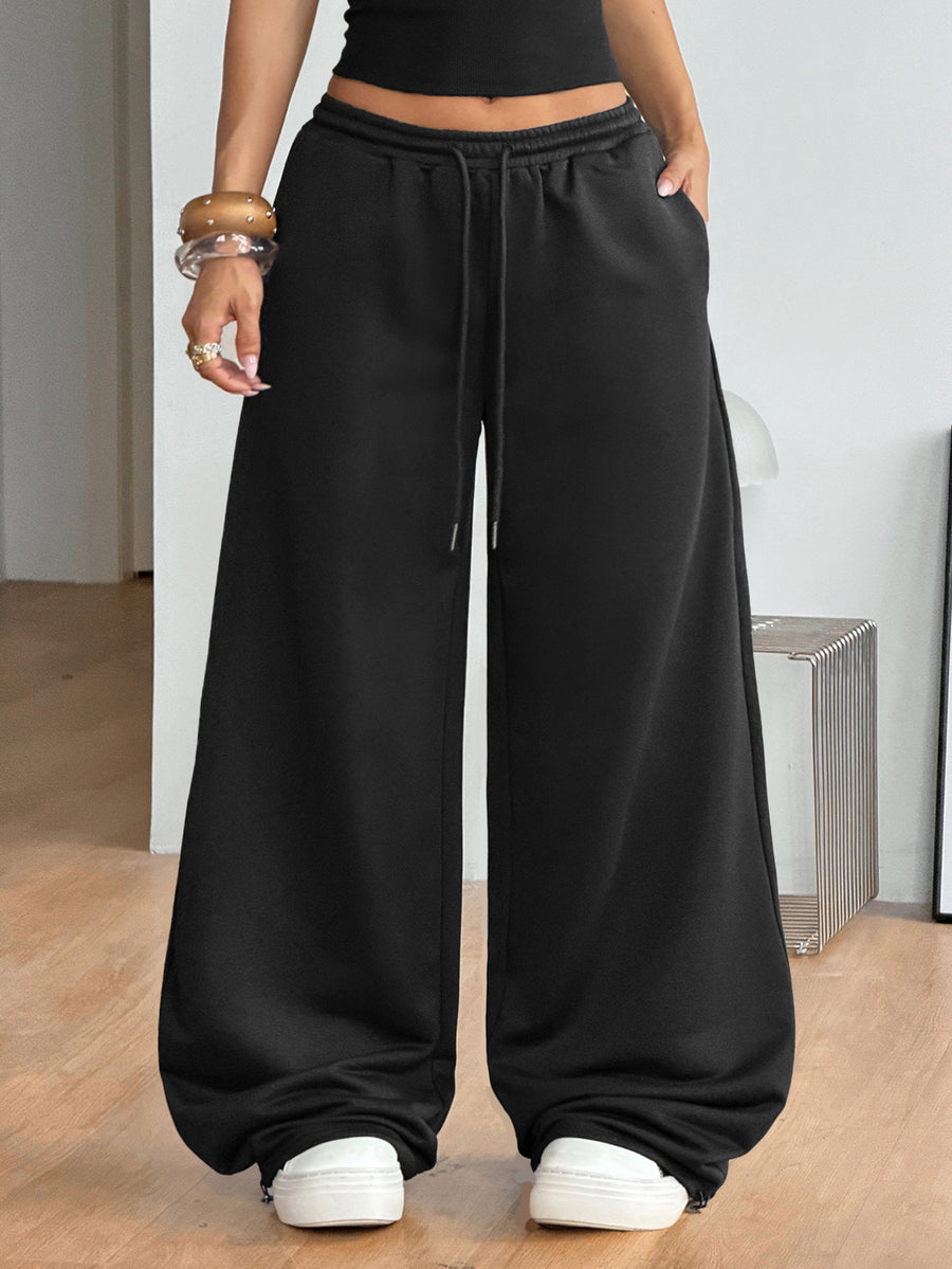 Women's loose fit wide leg graphic sweatpants in light grey with an elastic drawstring waistband