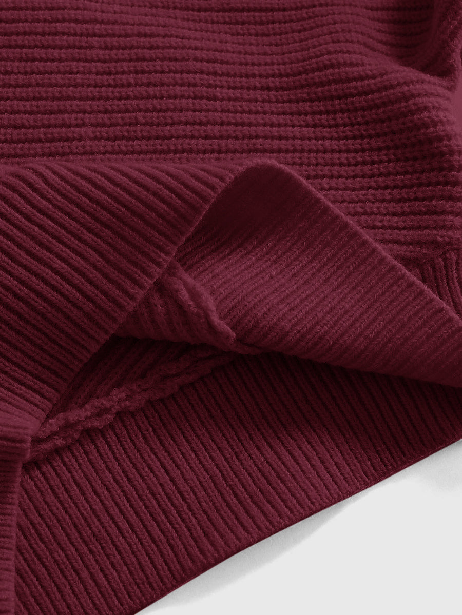 Women's two-piece rib-knit sweater set featuring a long-sleeve cold-shoulder crop top with strap details and matching wide-leg pants.