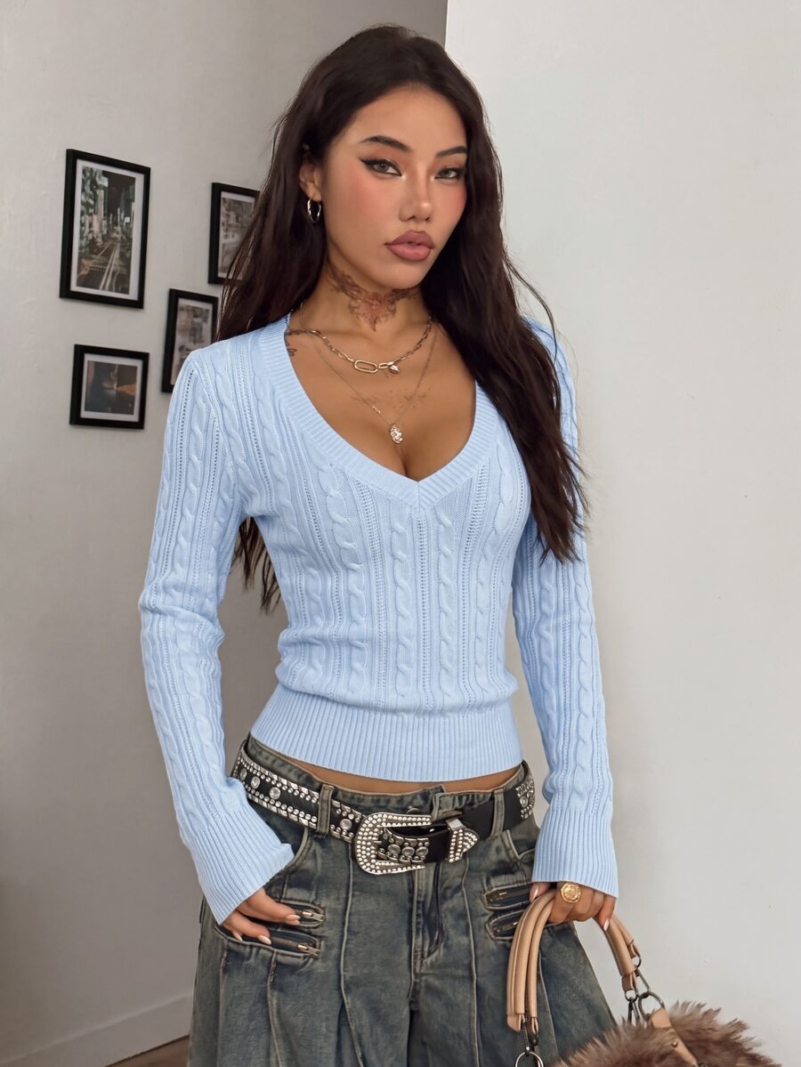 Women's slim fit cable-knit sweater with a V-neckline and long sleeves in solid green rib knit fabric.