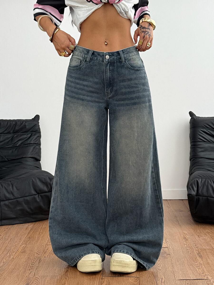 Loose wide leg denim jeans for women featuring a low waist, functional pockets, zipper fly closure, and extra long relaxed fit.
