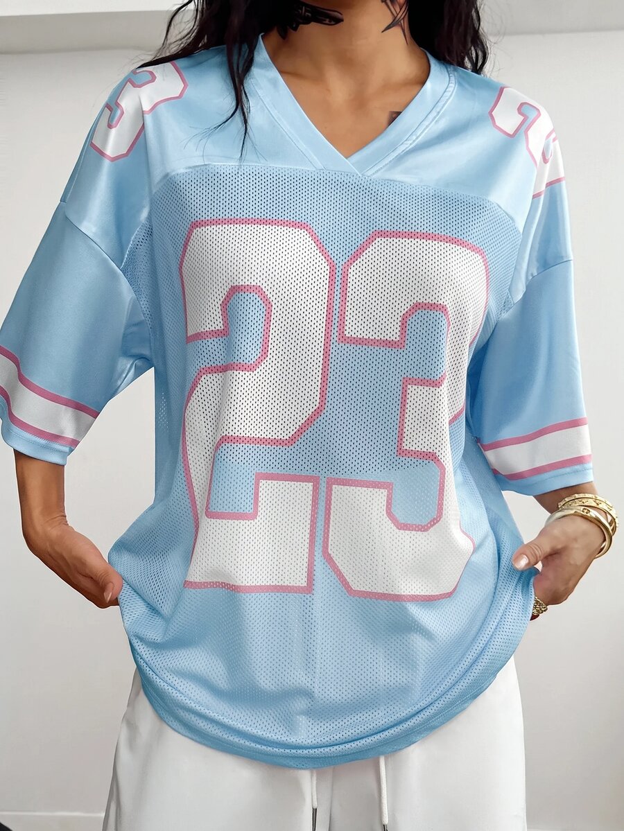Oversized short-sleeve football jersey top featuring a V-neckline, contrast binding, and graphic number print.