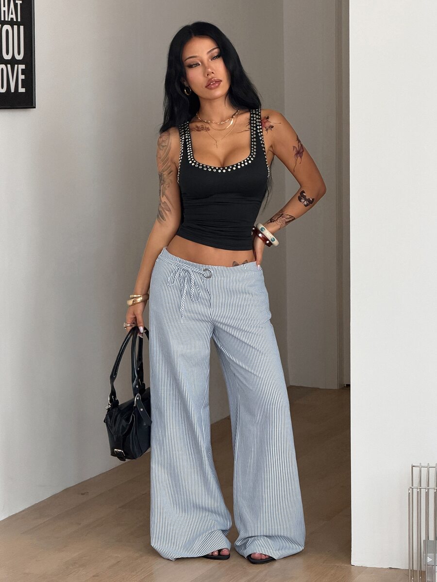 Women's blue and white striped woven wide leg long pants featuring side knot ties and grommet eyelet details.