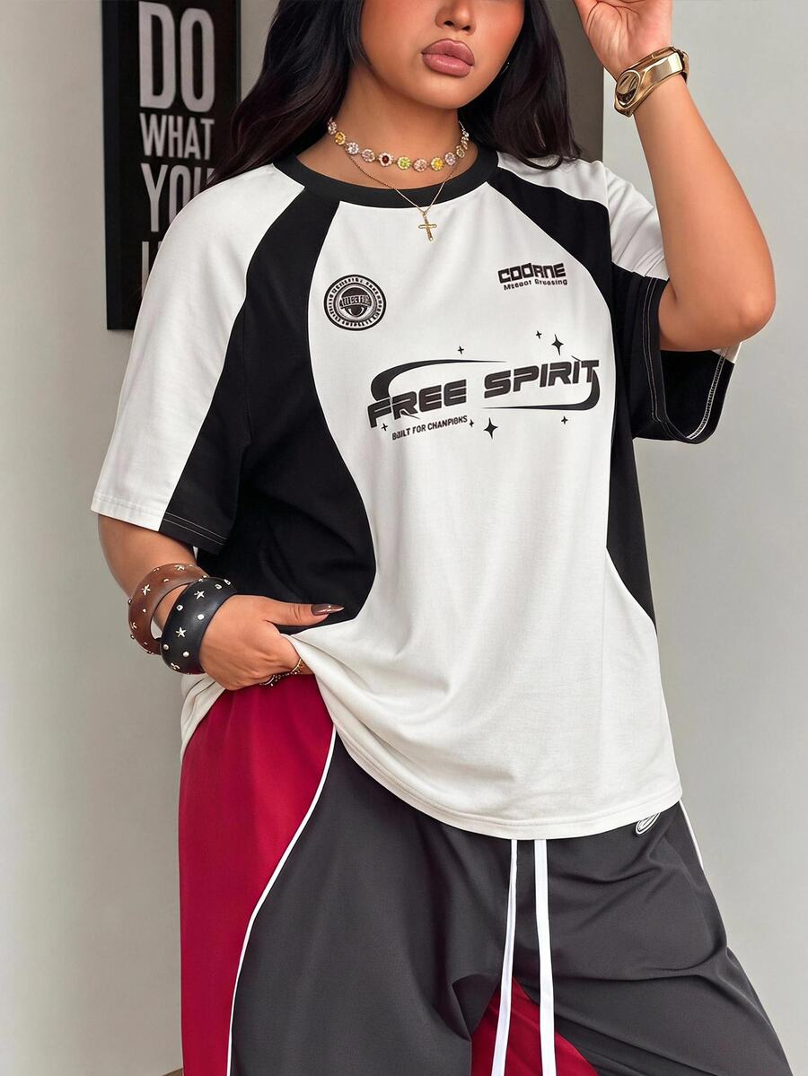 Unisex plus size oversized jersey t-shirt in brown featuring a round neck, short raglan sleeves with contrast binding, and a front letter graphic print.