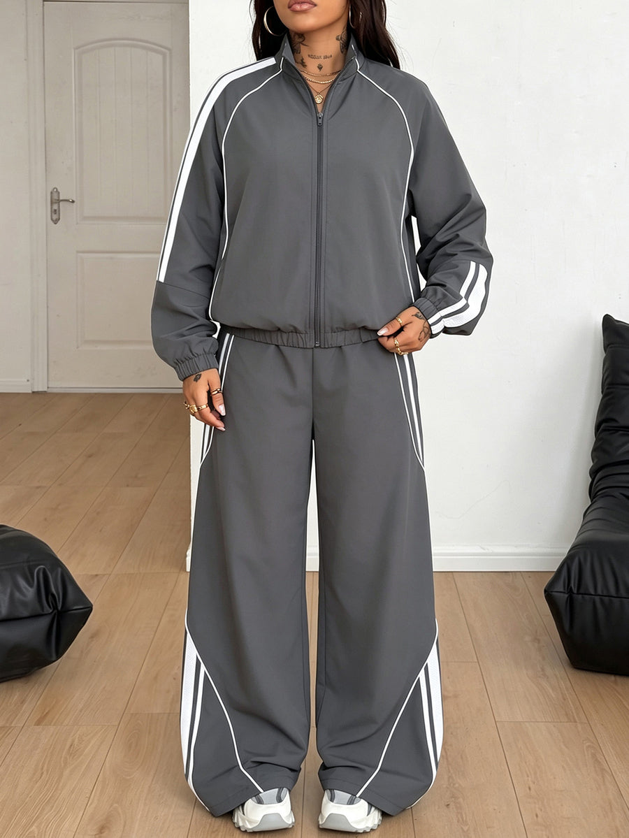 Women's two-piece sporty casual tracksuit set featuring a stand collar zip-up jacket with contrast binding and matching loose parachute pants.