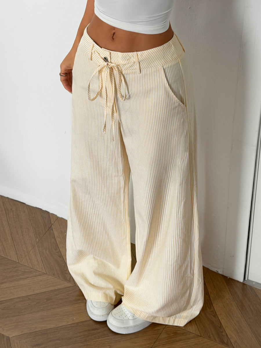 Women's casual straight leg striped woven pants featuring a low waist and zipper fly closure.