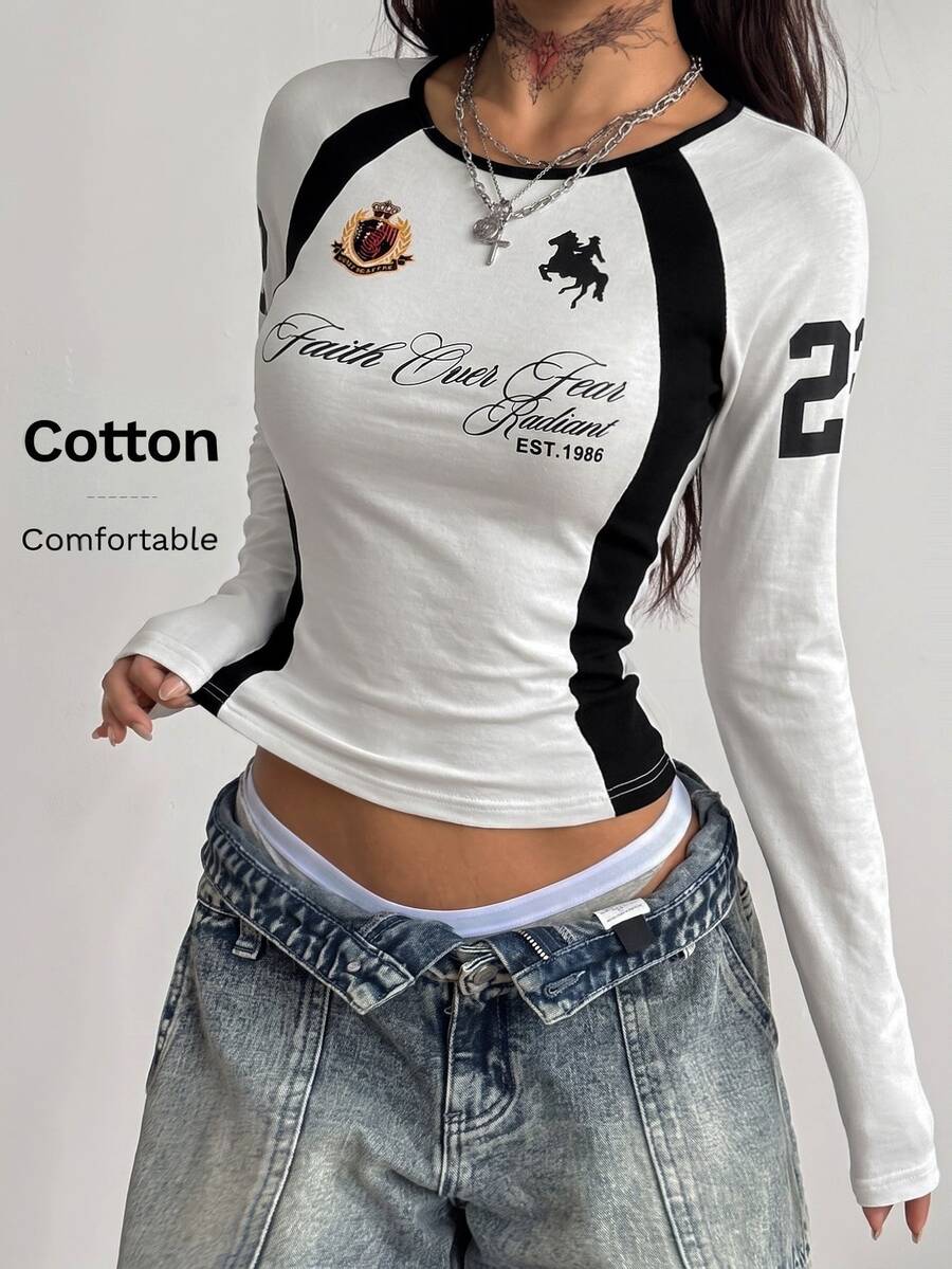 Women's slim fit long sleeve raglan t-shirt with collegiate letter graphic print, round neck, and contrast binding.