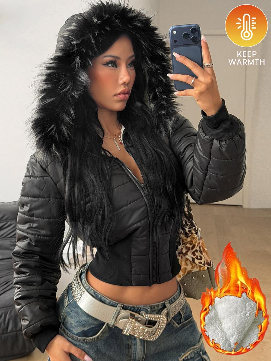 Women's brown cropped puffer jacket featuring a faux fur trimmed hood, front zipper, and ribbed hem.