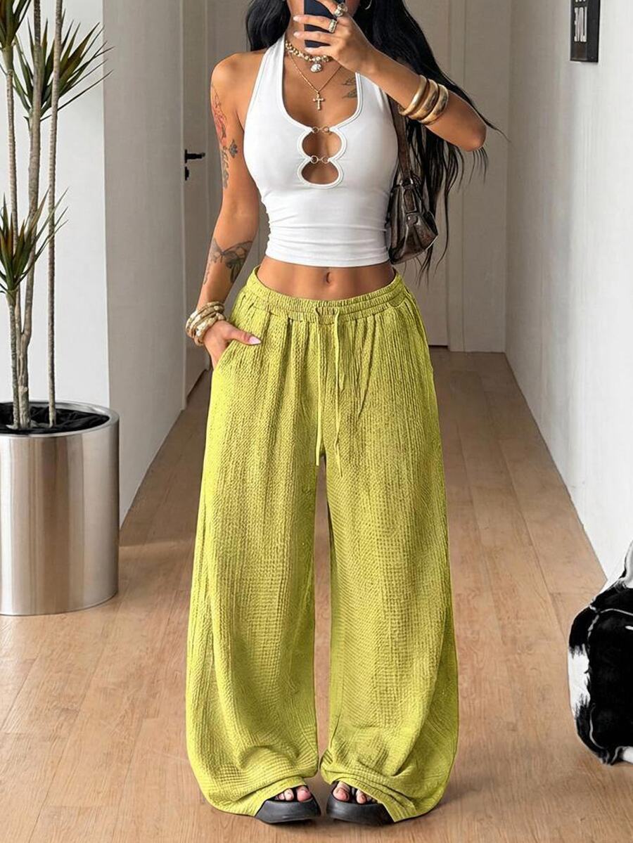 Women's loose fit straight leg lounge pants in textured knit fabric featuring an elastic drawstring waist and side pockets