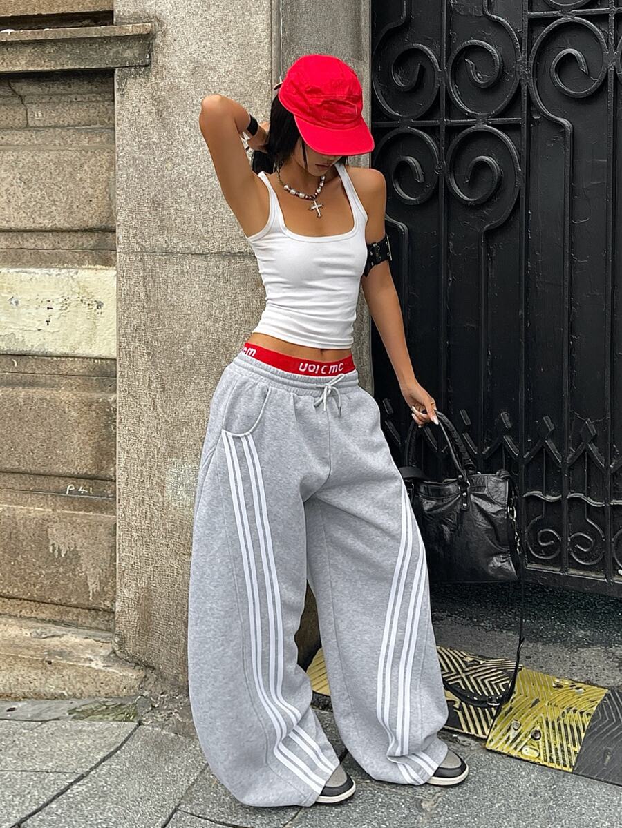 Women's casual grey plaid sweatpants featuring an elastic drawstring waistband, side pockets, and a relaxed loose fit.