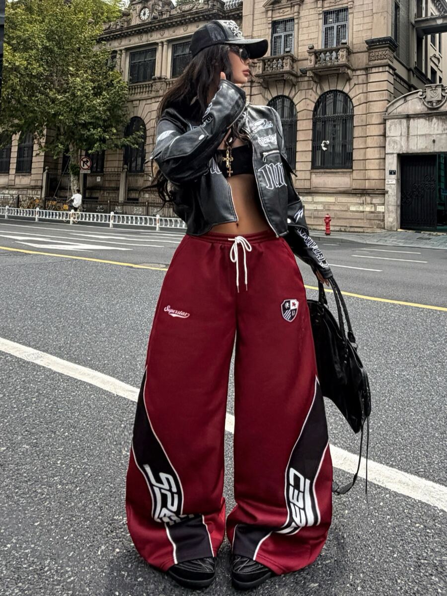 Women's loose fit wide leg graphic sweatpants in light grey with an elastic drawstring waistband