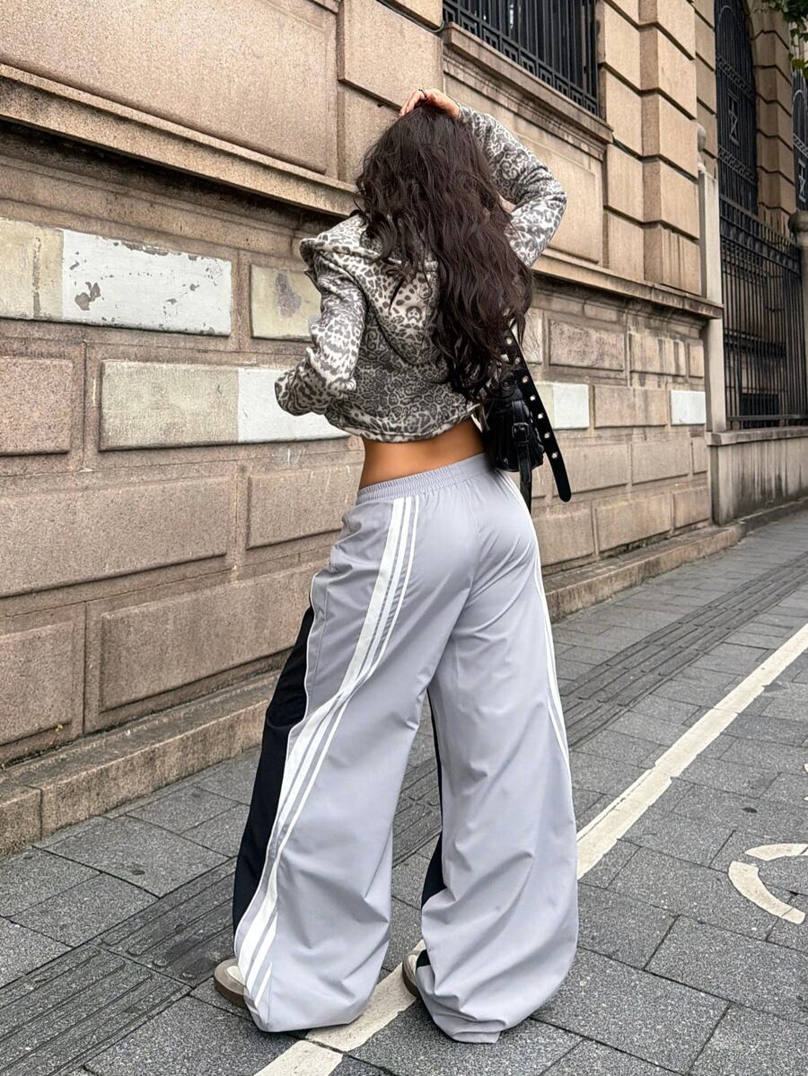 Women's loose fit straight leg pants in black and white with banded texture design, low drawstring waist, and pockets.