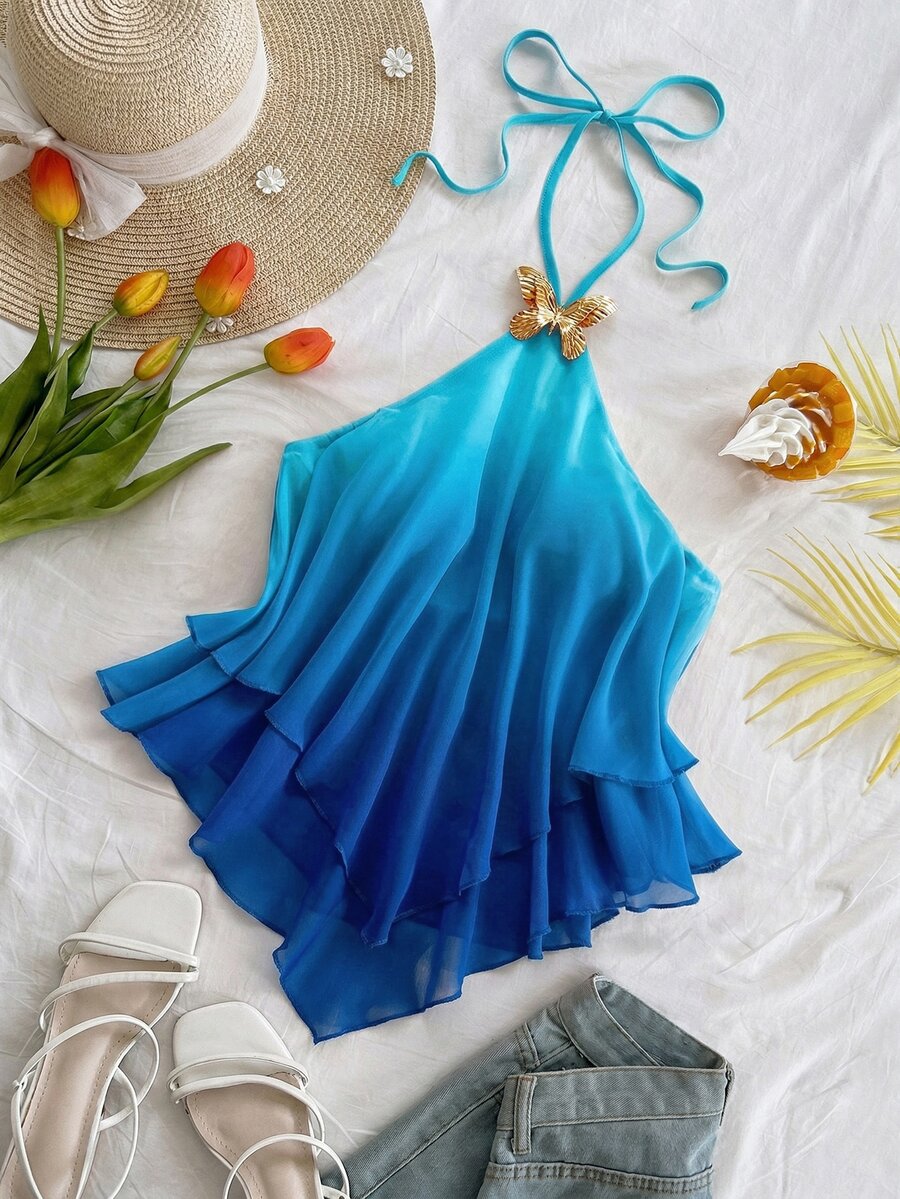 Women's gradient halter top with draped neck, butterfly metal accent, backless cut, and asymmetrical hem