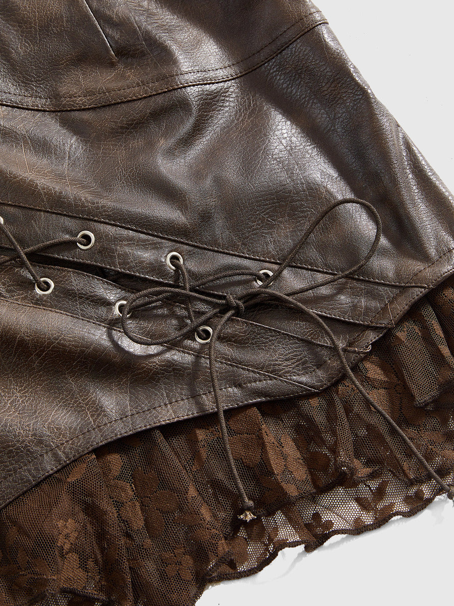 Women's washed PU leather mini skirt with contrast lace trim, wrap knot tie detail, and asymmetrical hem.