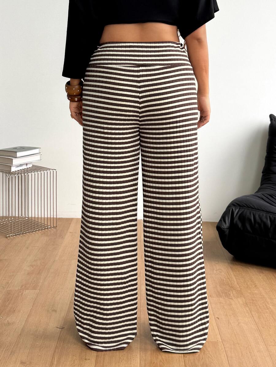 Women's casual straight leg sweatpants featuring a black and white polka dot design with an elastic waistband.
