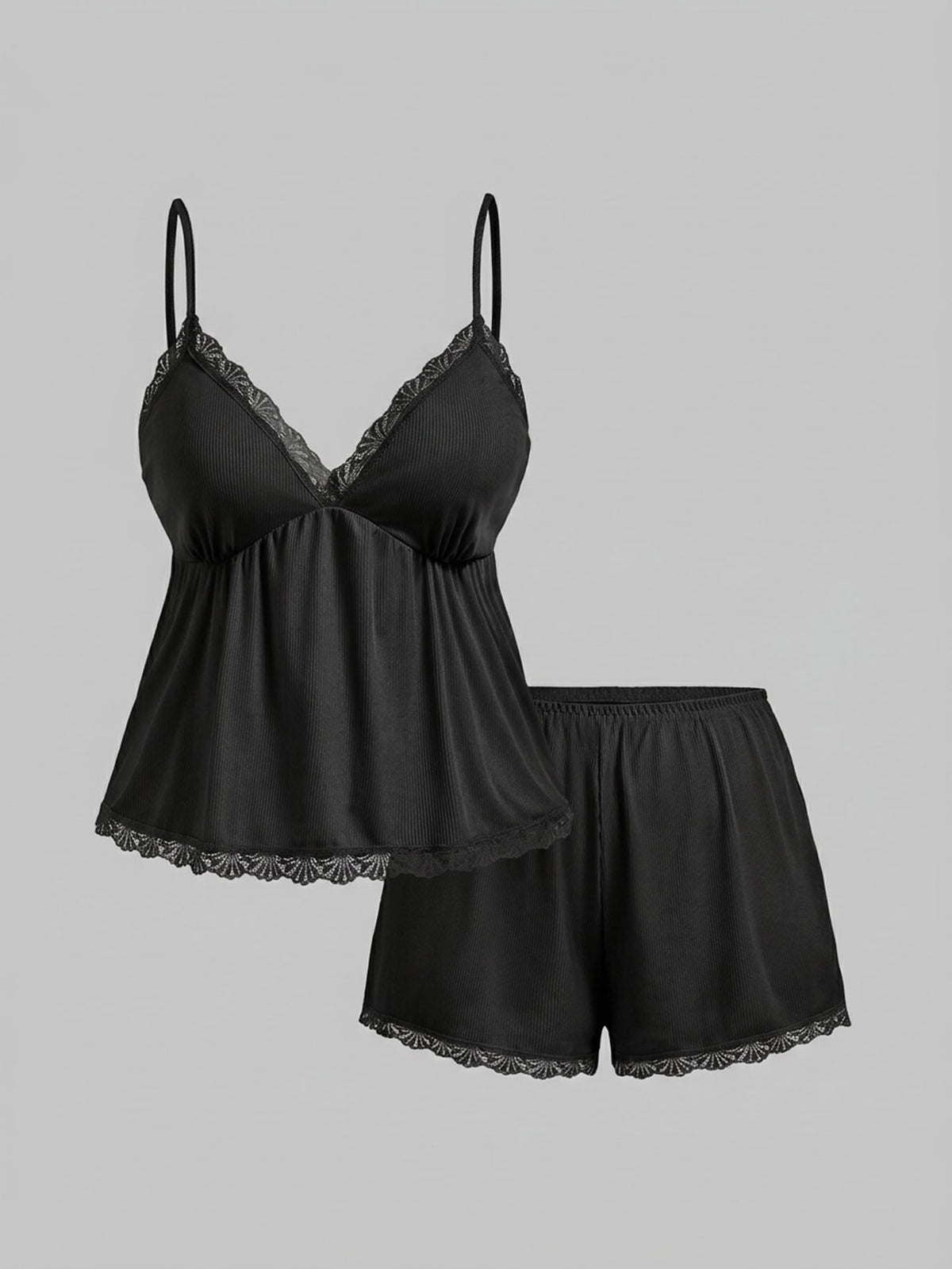 Two-piece ribbed pajama set featuring a lace-trimmed crop camisole top with spaghetti straps and matching shorts.