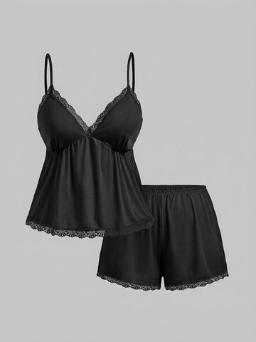 Two-piece ribbed pajama set featuring a lace-trimmed crop camisole top with spaghetti straps and matching shorts.