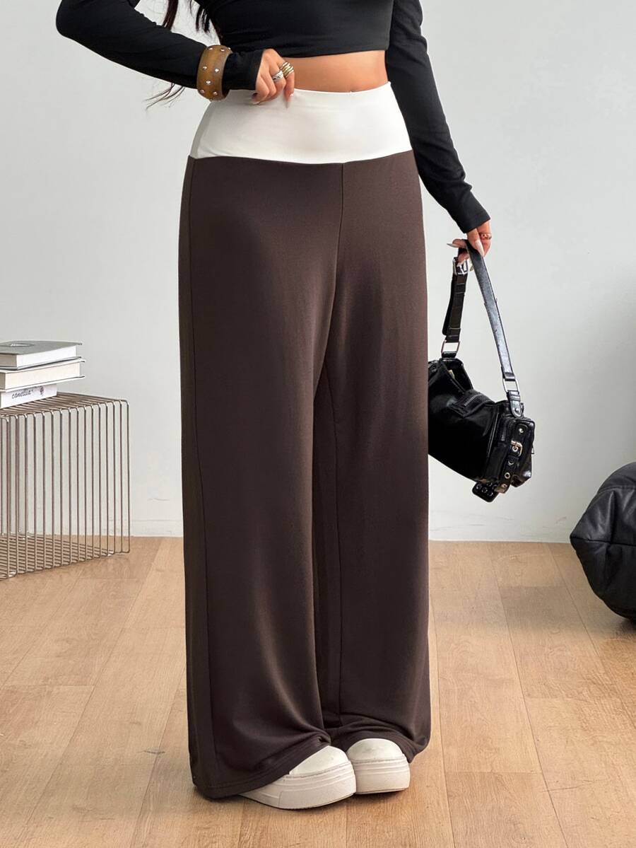 Women's casual straight leg sweatpants featuring a black and white polka dot design with an elastic waistband.
