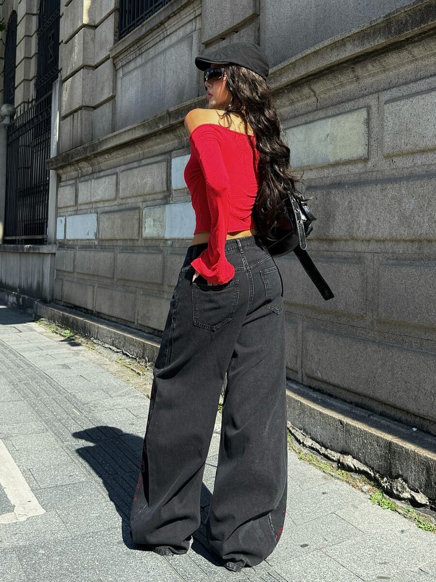 Front view of women's loose wide leg denim jeans featuring a mid waist, classic front pockets, and a zipper fly closure.