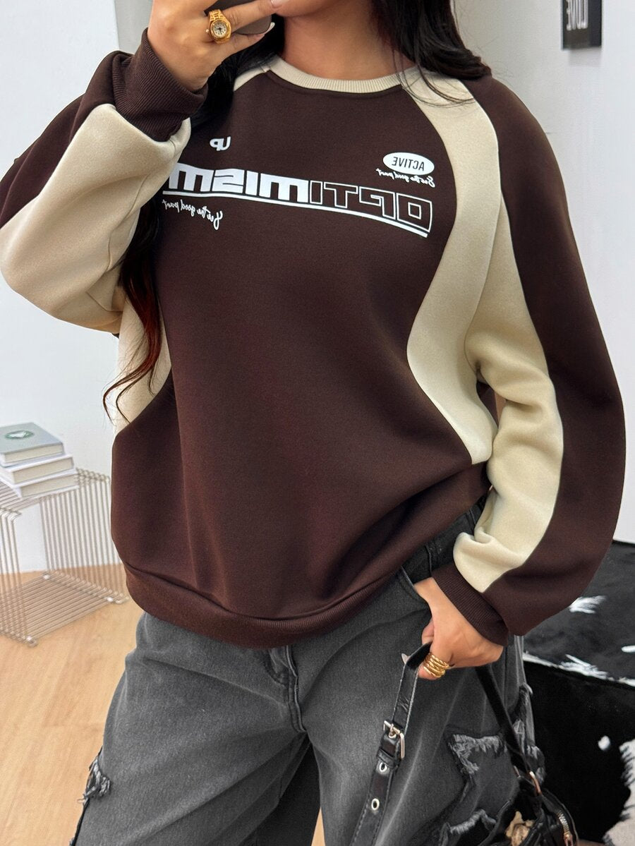Color-blocked loose pullover sweatshirt with a round neckline, raglan sleeves, and ribbed knit trim.