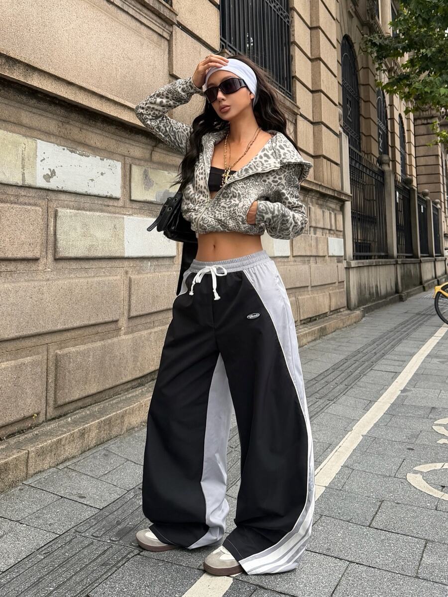 Women's loose fit straight leg pants in black and white with banded texture design, low drawstring waist, and pockets.