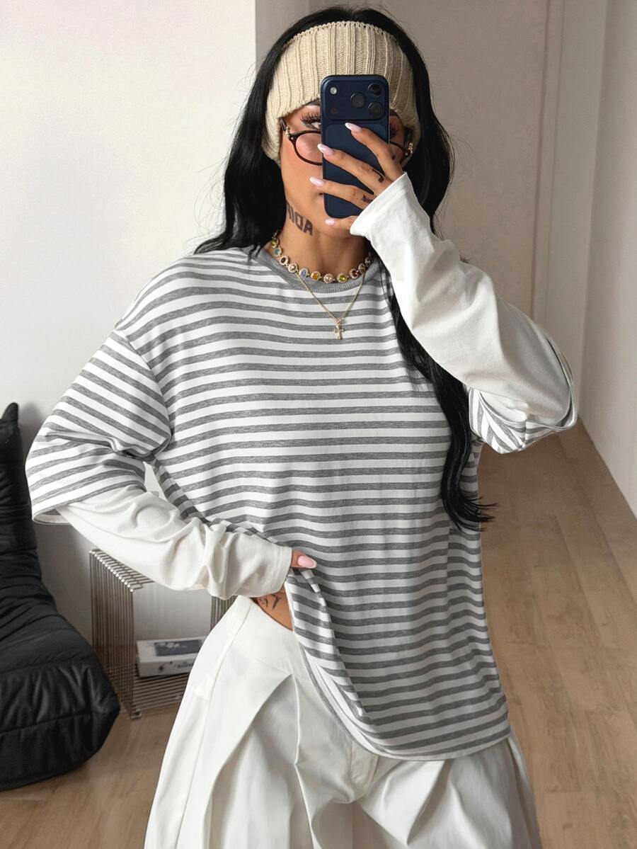 Women's casual graphic long sleeve t-shirt with a round neck, drop shoulder sleeves, and loose relaxed fit.