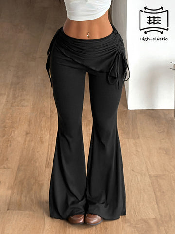 Women's black low rise flare pants with split hem detailing and stretchy knit fabric