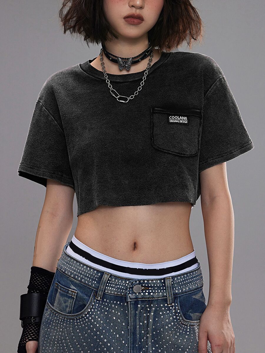 Women's short sleeve crop top with a round neckline and drop shoulder design in black knitted fabric.