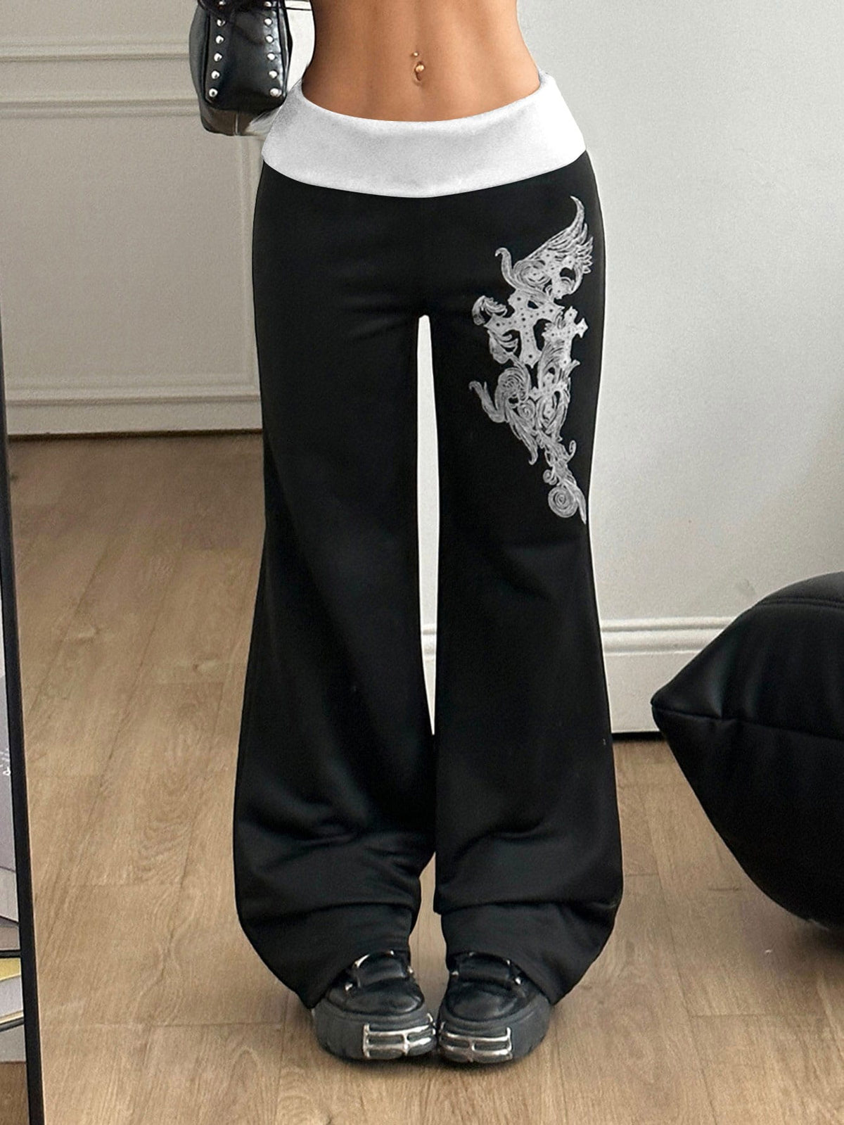 Women's black low waist wide leg flare sweatpants with rib-knit texture and contrast binding details.