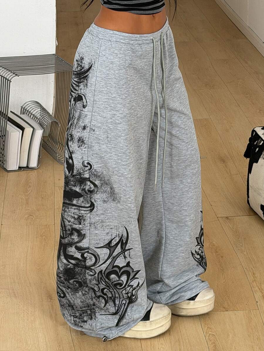 Women's loose fit wide leg graphic sweatpants in light grey with an elastic drawstring waistband
