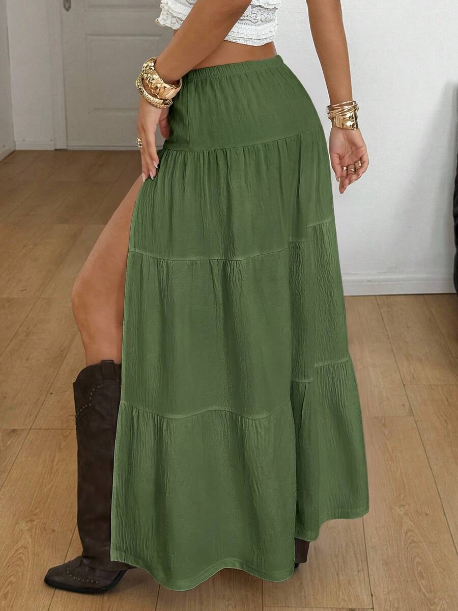 Women's red plaid long skirt featuring a low-rise waist and a side slit in lightweight woven fabric.