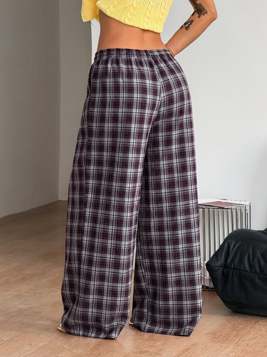 Women's loose fit brown and tan plaid wide leg pants featuring an elastic drawstring waist and side pockets.