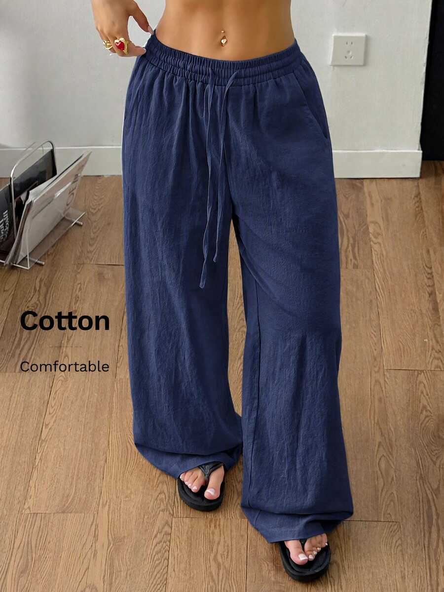 Plus size women's striped loose straight leg cropped pants with pleated detailing and side pockets