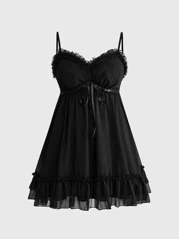 Front view of a black goth cami mini dress featuring cold shoulder spaghetti straps, chiffon fabric, and a tiered ruffle flounce hem.