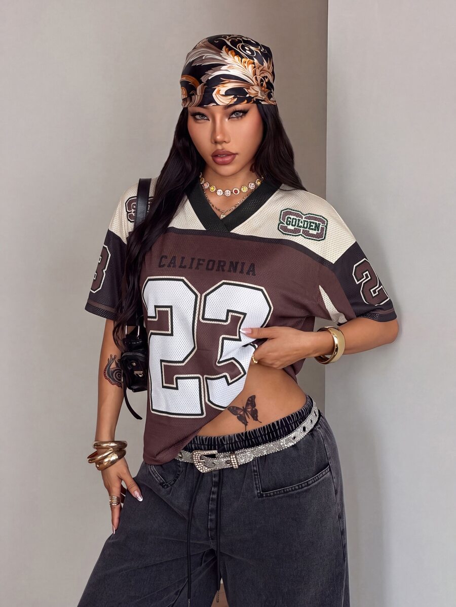 Women's oversized short sleeve graphic T-shirt with vintage digital geometric print, V-neck, and asymmetrical hem